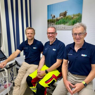 Dr. Hark Weber, Dr. Thies Weber und Dr. Moritz Hemicker vor der Praxis im Meer in Utersum.