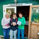 Anne Maitschke (Mitte) mit Spendengeld und zwei Helferinnen der Igelhilfe Föhr vor dem Igelhaus in Wyk auf Föhr.